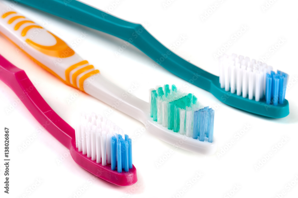Three toothbrushes isolated on a white background closeup Three toothbrushes isolated on a white background closeup