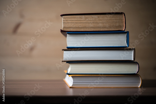 Stack of books on wooden table. Education concept.