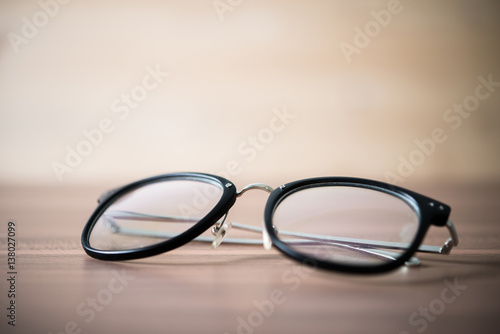 black glasses on wooden table. Close-up a black glasses.
