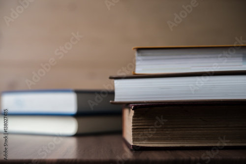 Stack of books on wooden table. Education concept.