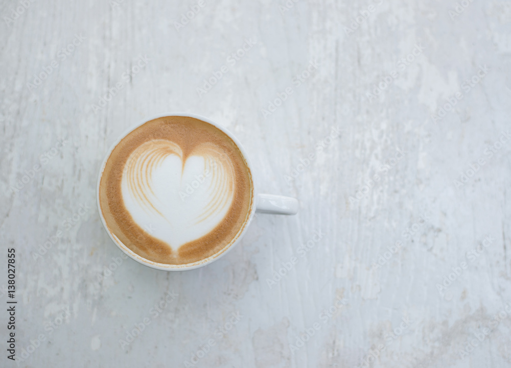 Cup of latte art heart shape coffee on white table. Cup of latte art heart shape coffee on white table.