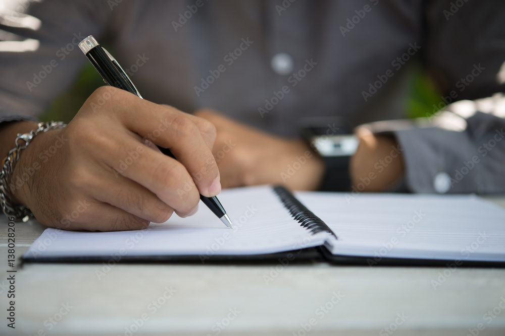 Hipster education man writing on notepad, While sitting relaxing at home garden. Hipster education man writing on notepad, While sitting relaxing at home garden.