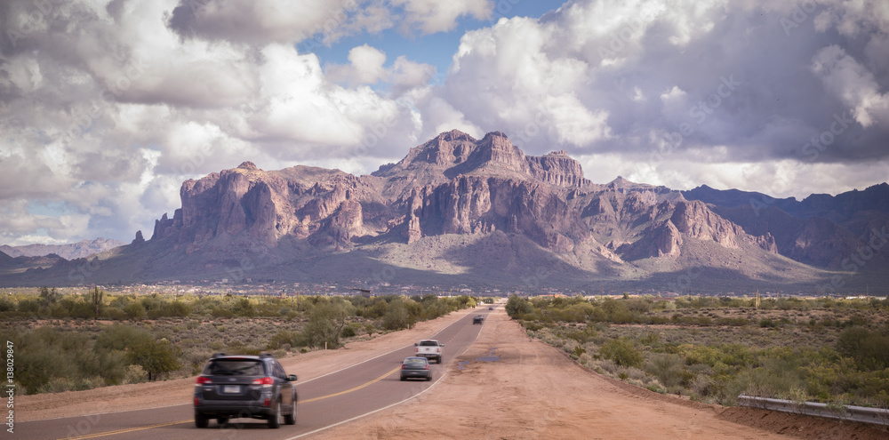 Fototapeta premium Arizona desert road leading to Superstition Mountain near Phoenix,Az,USA