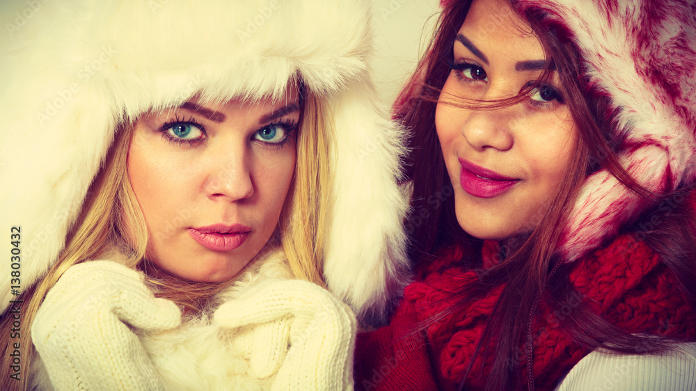 Two girls in warm winter clothing portrait. Two girls in warm winter clothing portrait.