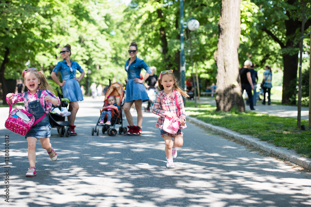 twins mother with children  in city park