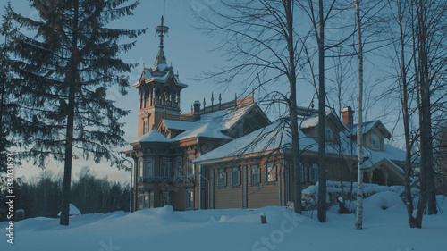 Beautiful traditional snow-covered russian cottage - terem in a forest.