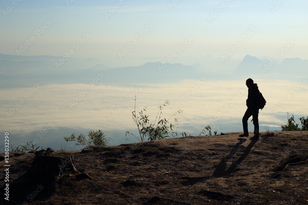 Fototapeta premium Man walking on the cliffs and mist at Phu Kradung National Park,Thailand