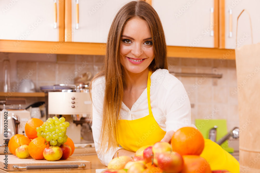 Female cook working in kitchen.