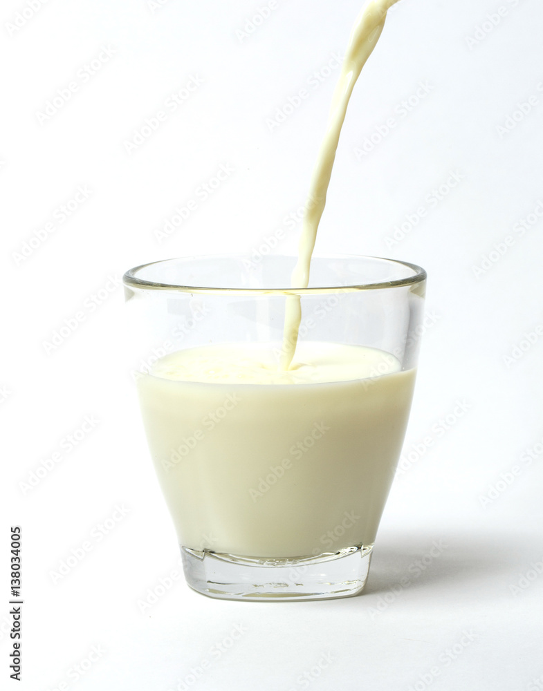 Pouring a cup of milk creating splash Pouring a cup of milk creating splash