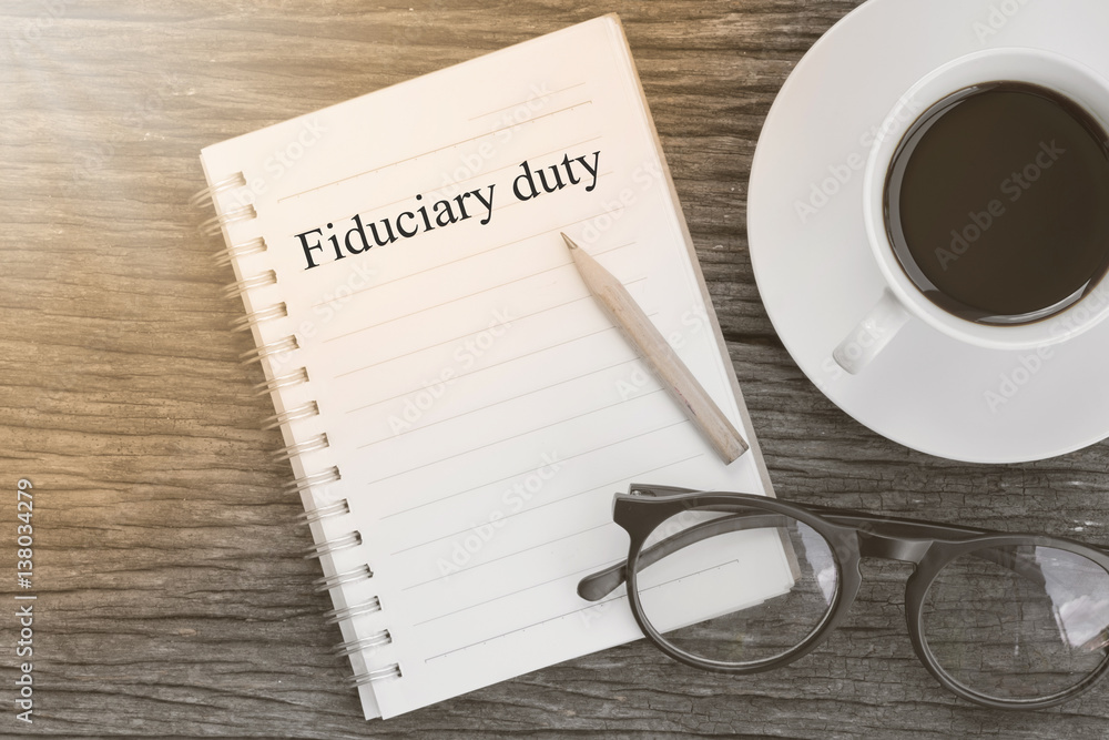 Plakat Concept Fiduciary duty message on notebook with glasses, pencil and coffee cup on wooden table.