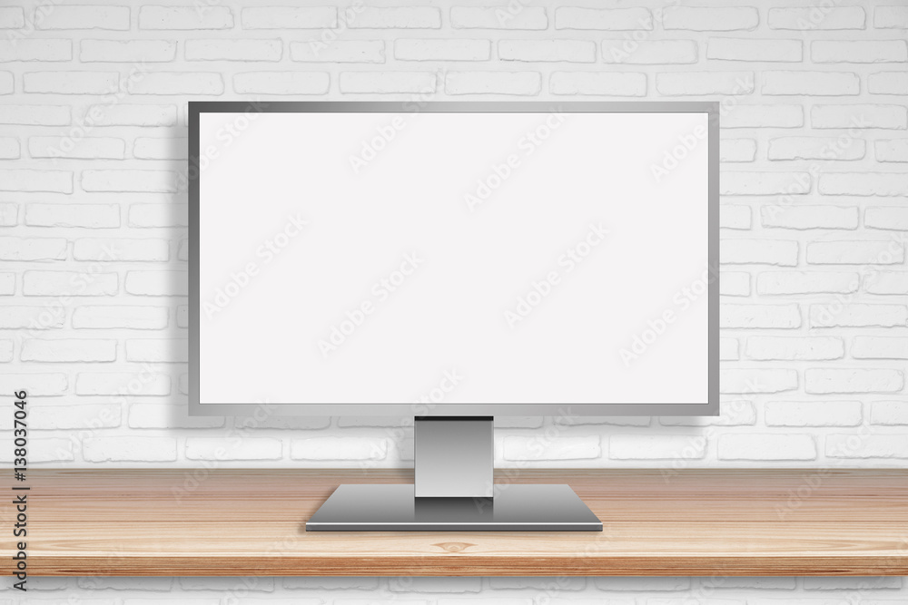 Fototapeta premium Computer Mornitor with blank screen on wood table with white wall