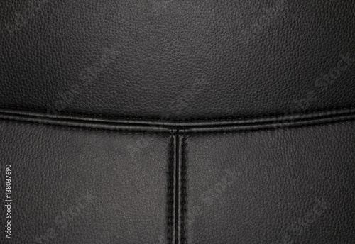 Black leather texture background surface with seam. Macro shot.