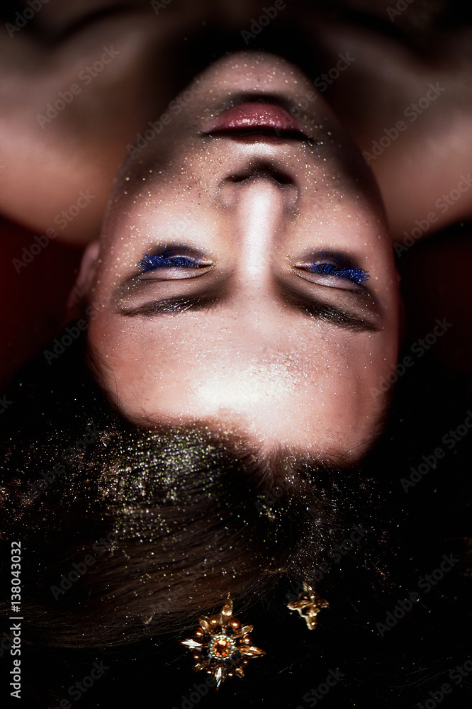 Studio portrait of a beautiful girl with long hair. Glitter on your face. Beautiful eyes. Dark background. Mysterious, mystical, Studio portrait of a beautiful girl with long hair. Glitter on your face. Beautiful eyes. Dark background. Mysterious, mystical,
