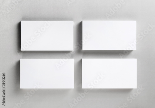 Four blank piles business cards on paper background. Template for ID. Business mockup. Blank objects for placing your design. Mock up for branding identity. Top view.