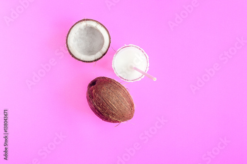 cocktail with coconut on purple background top view