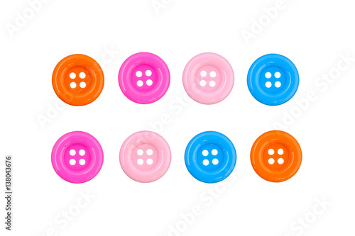 Various sewing buttons with a thread isolated on white background