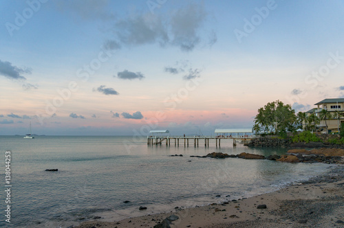Pier  jetty  berth in tropical surroundings against sunset sky
