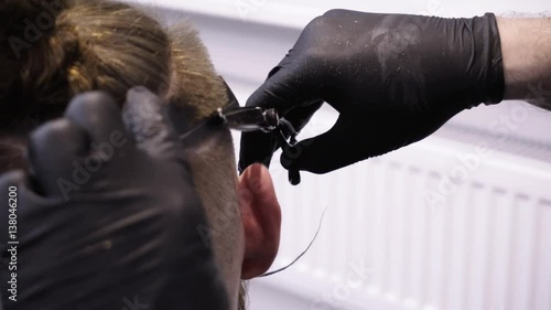 Men's hairstyling and haircutting in a barber shop or hair salon.