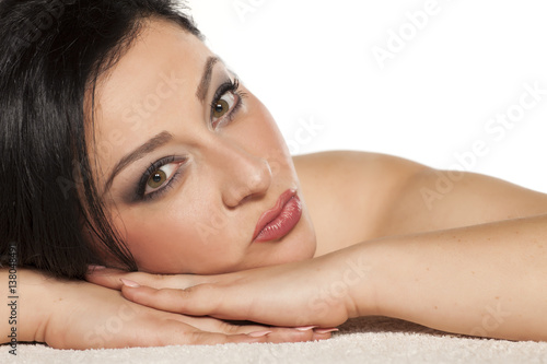 portrait of a young beautiful woman lying on the towel