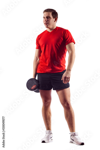 Muscular guy doing exercises with dumbbells over white background