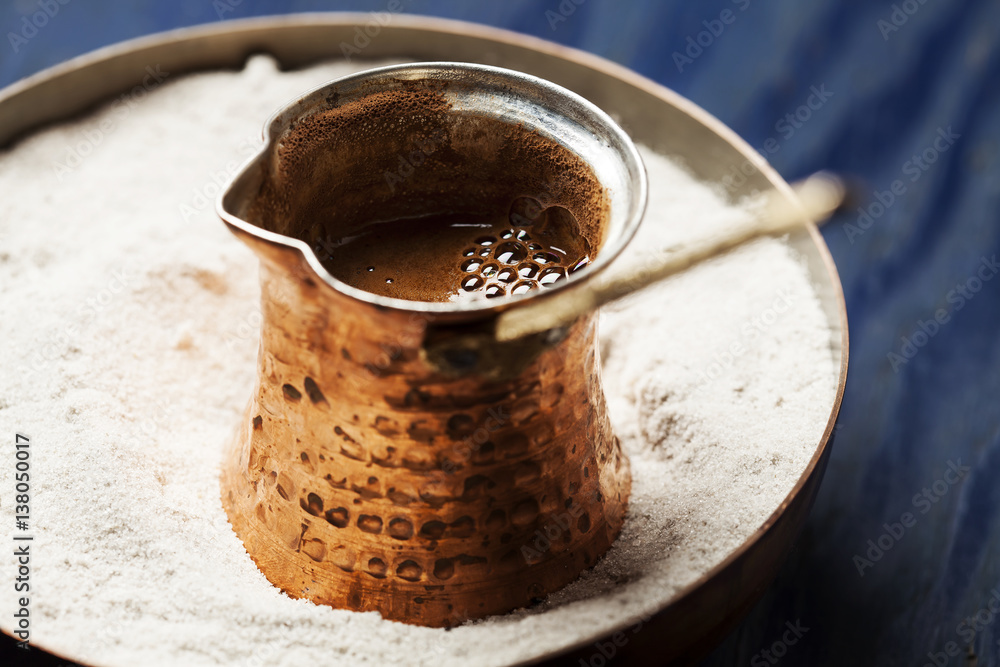 Turkish coffee made in cezve (traditional coffee pot) on sand Stock Photo |  Adobe Stock