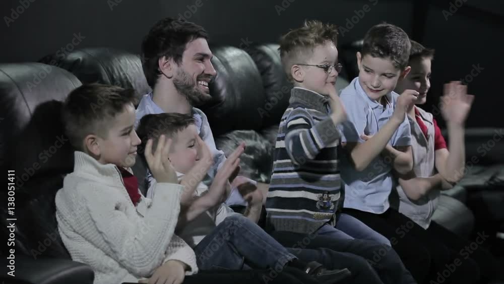 The man and children are waving the hands into the camera The man and children are waving the hands into the camera
