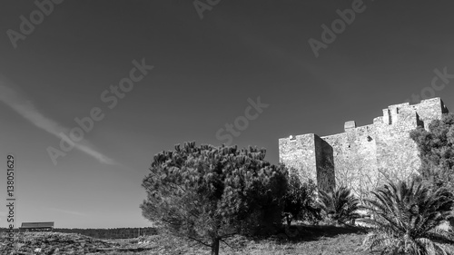 The ancient Rocca Aldobrandesca of Talamone, Grosseto, Tuscany, Italy, on a beautiful sunny day, in black and white photo