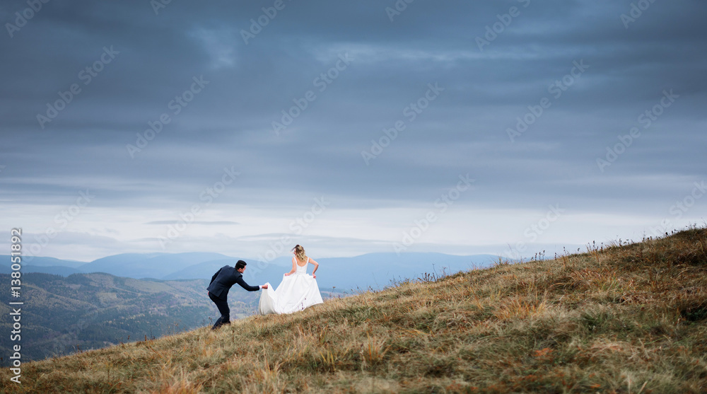The brides running along hillside