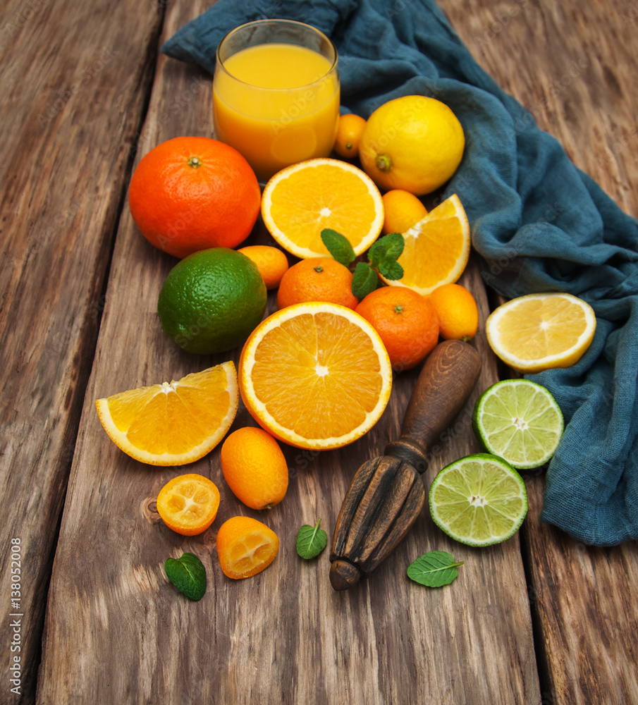 Fresh citrus fruits and old juicer Fresh citrus fruits and old juicer