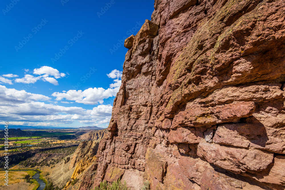 The sheer rock walls. Unusual shaped rocks on the background of blue sky. Beautiful landscape of yellow sharp cliffs. Smith Rock state park, Oregon The sheer rock walls. Unusual shaped rocks on the background of blue sky. Beautiful landscape of yellow sharp cliffs. Smith Rock state park, Oregon