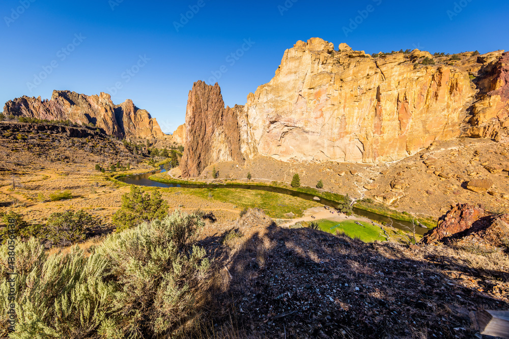 The river is flowing among the rocks. Colorful Canyon. Amazing landscape of yellow sharp cliffs. Smith Rock state park, Oregon