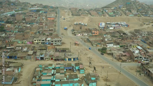 Ventanilla Peru Aerial v21 Flying low over urban poverty hillside housing area. photo
