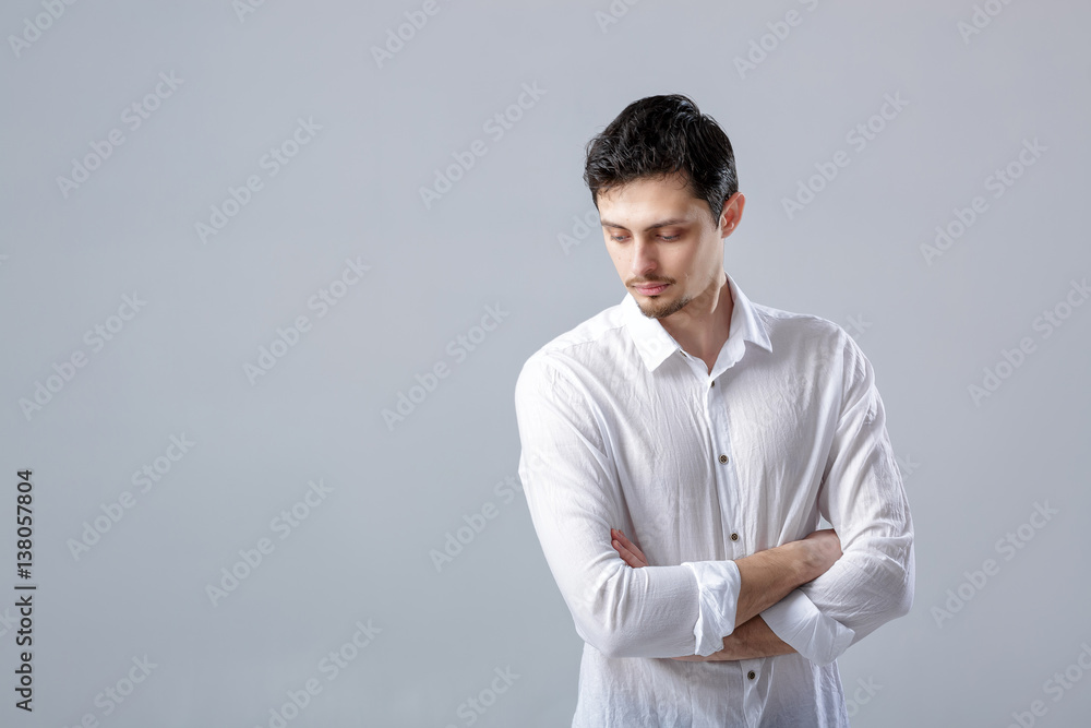 portrait of handsome young man with dark hair in white shirt on portrait of handsome young man with dark hair in white shirt on