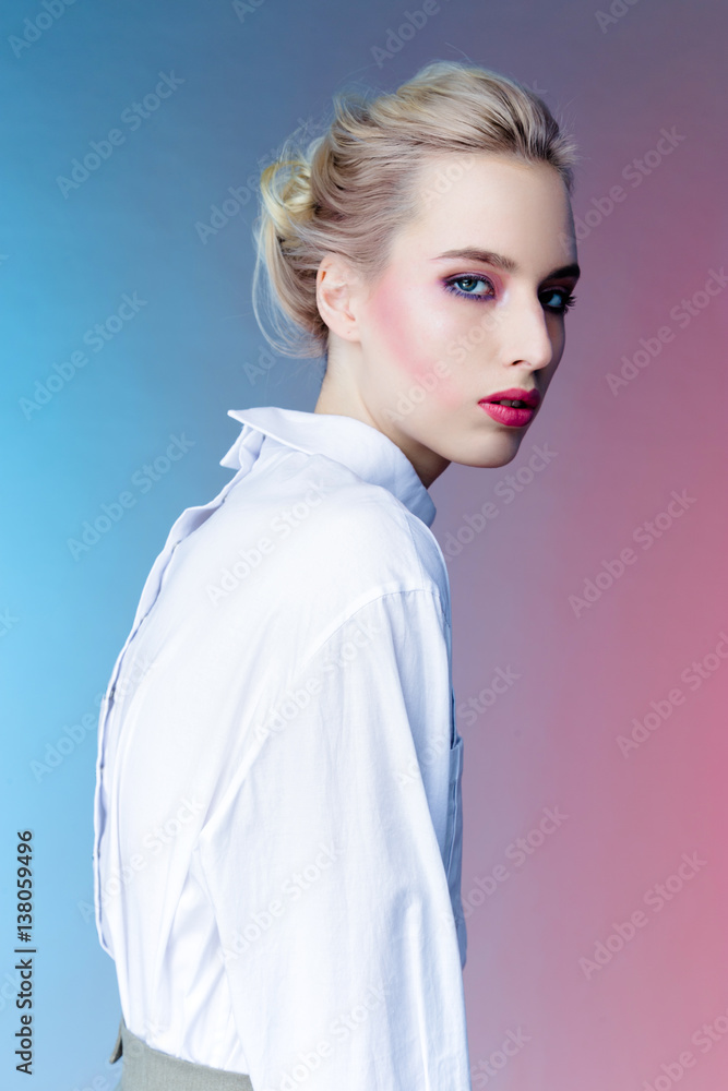beautiful young woman with bright makeup in white clothing posing on colorful background beautiful young woman with bright makeup in white clothing posing on colorful background
