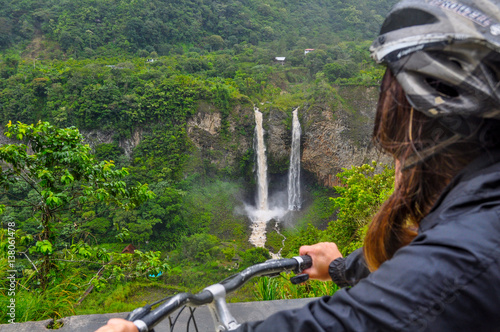 Woman  riding bicycle at Banos, Ecuador
