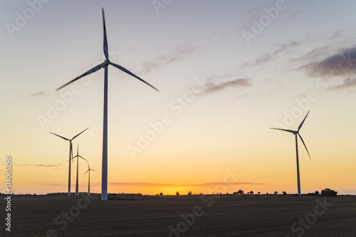 windmills at sunrise on a spring field