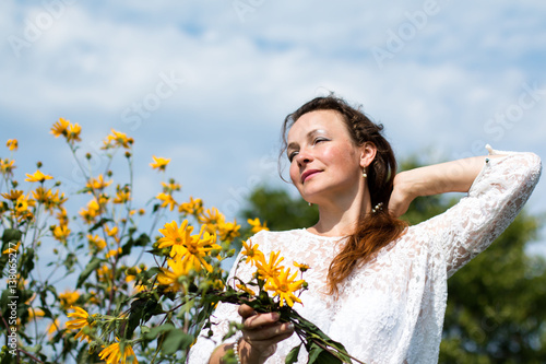 Nice girl and flowers in a nice day photo