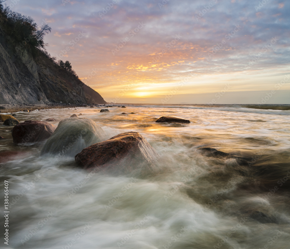 a spectacular, dynamic sunset around the cliffs in Wolin national park in Poland a spectacular, dynamic sunset around the cliffs in Wolin national park in Poland