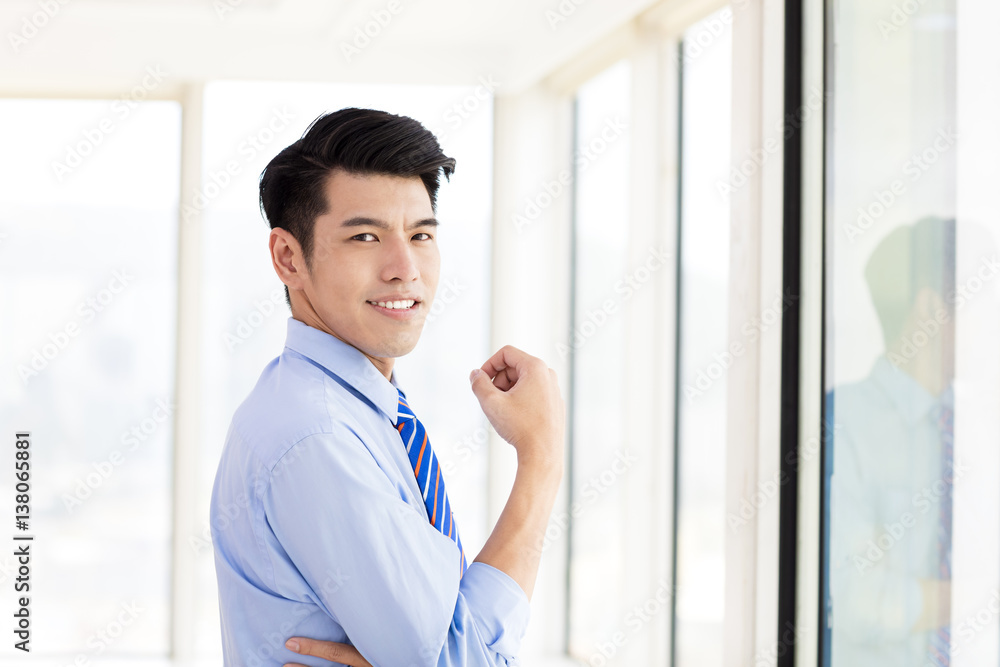 young Business man standing in office young Business man standing in office