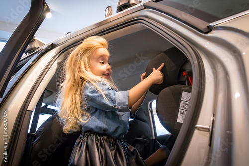 Small girl in car exhibition room © keleny