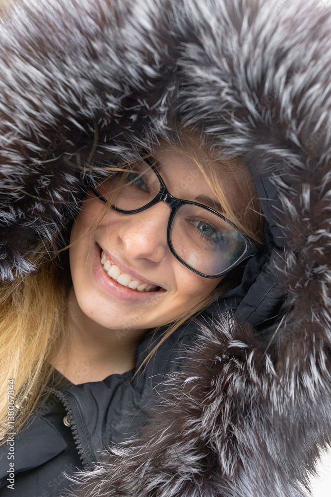 cheerful girl with a smile in a fur hood. cheerful girl with a smile in a fur hood.