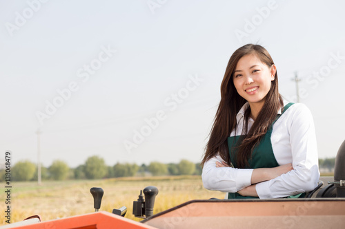 young asian woman agronomist in golden field