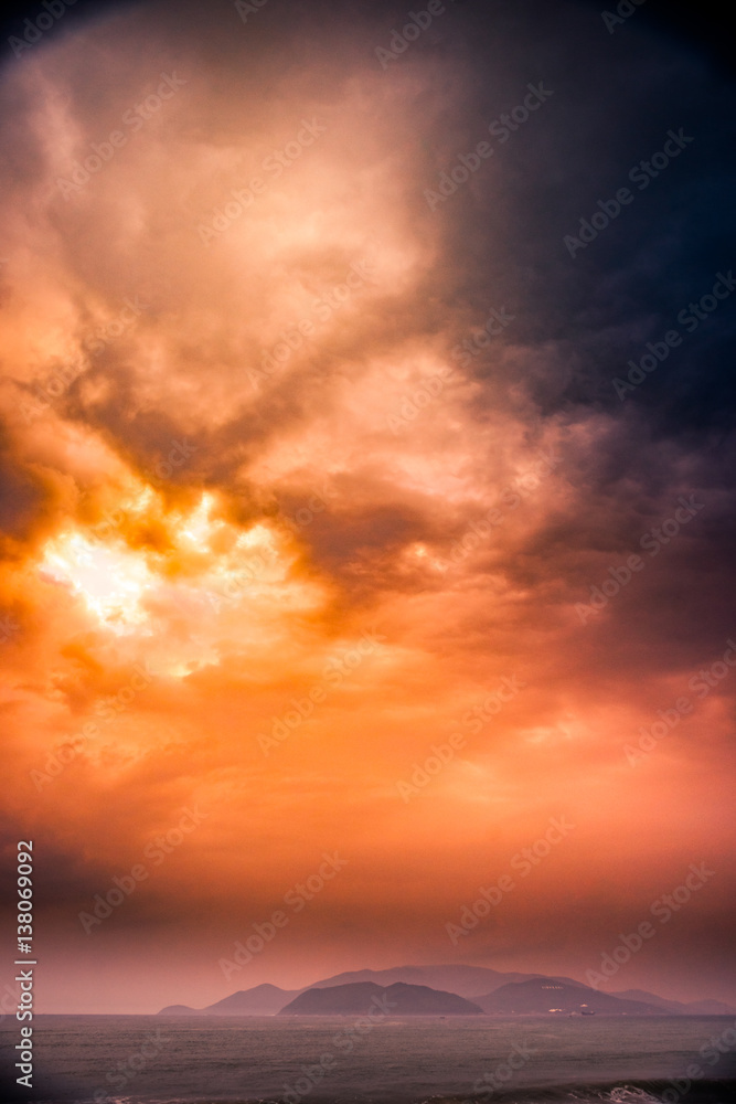 Fototapeta premium Nature in twilight period, Sunrise or Sunset over the sea with beach. Sea view from tropical beach with purple sky. Summer with blue sea water and purple sky. Vintage retro seascape
