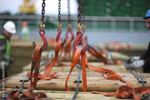 Chains and hooks hoist with slings for loading timber on board the vessel photo