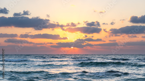 Sunset over Ocean - Bright Orange Sun Setting on Beautiful Blue Water