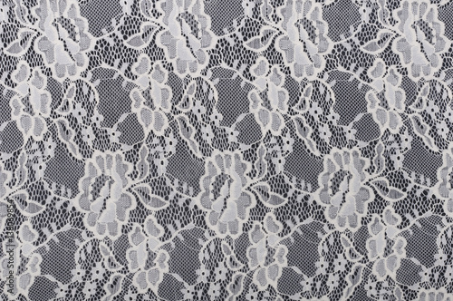 piece of white material with lace on black background