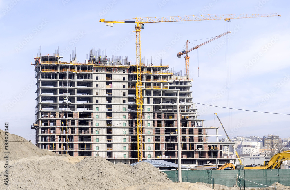 Building of large modern apartment scraper on the construction site Building of large modern apartment scraper on the construction site