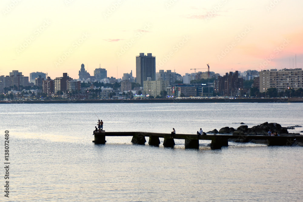 Naklejka premium Sunset scene of beach and skyline at background, Montevideo, Uruguay