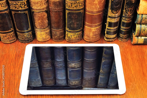 reflection of old books in tablet pc