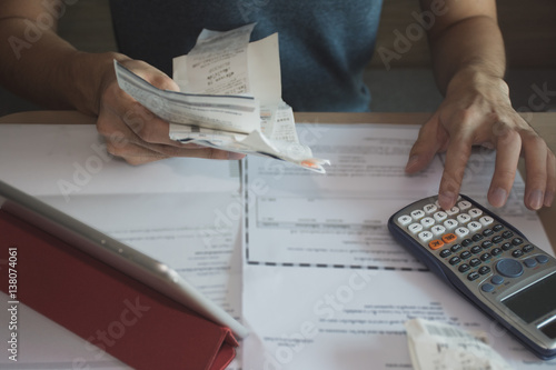 Photo man using calculator for  calculate expenses accounts